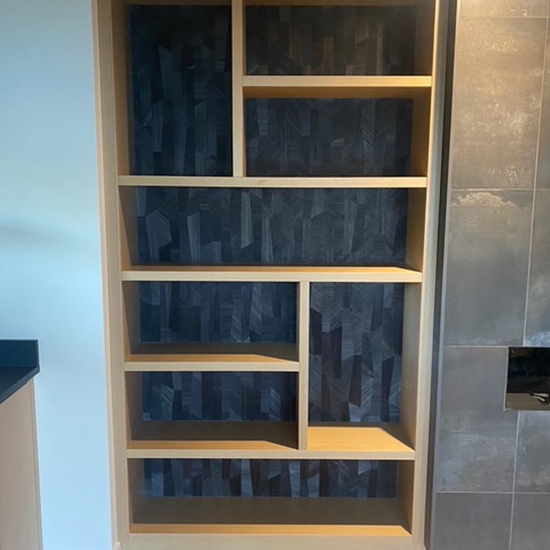 Kelowna geometric feature wall wallpaper behind built-in shelving